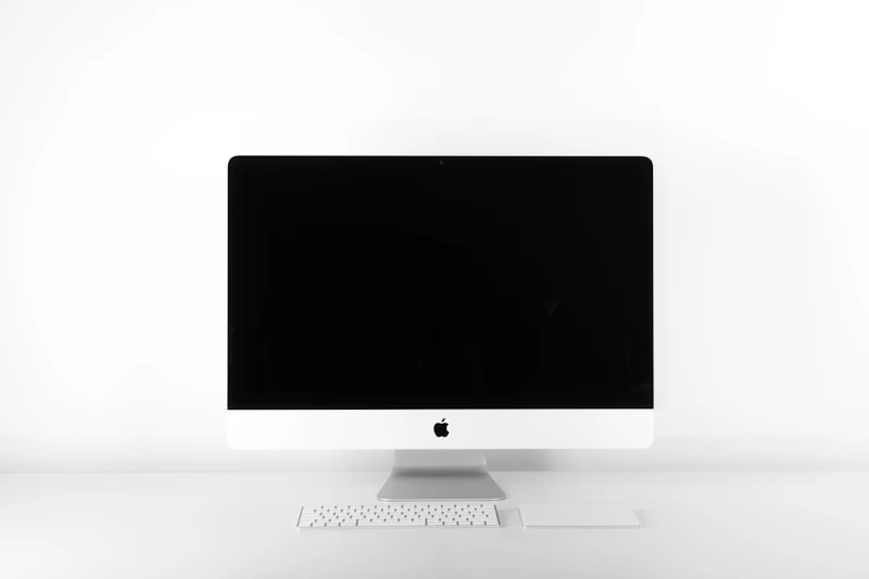 Minimal desktop display on a white desk